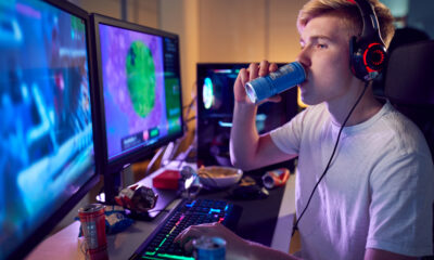 Teenage,Boy,Drinking,Caffeine,Energy,Drink,Gaming,At,Home,Using