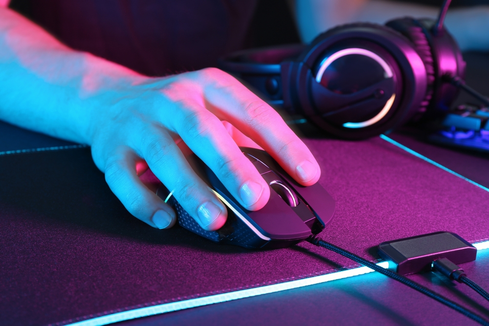 Gamer,Using,Modern,Wired,Computer,Mouse,In,Neon,Lights,At