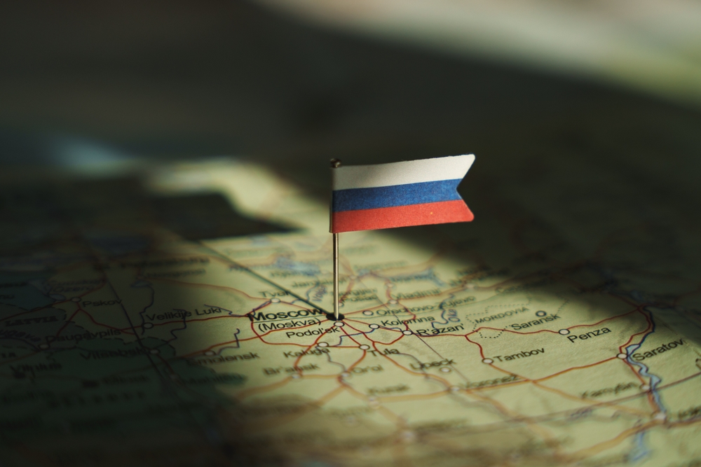 Russian,Federation,Flag,On,Russia,Map,Highlighted,By,Dramatic,Light.