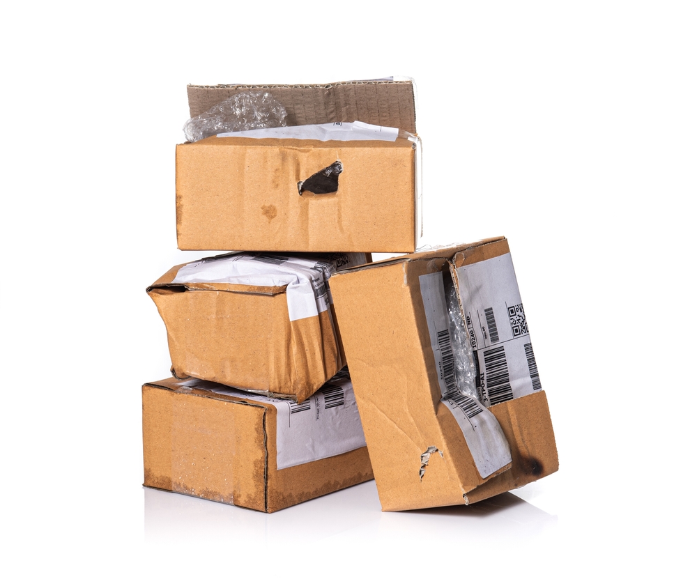 Damaged,Cardboard,Parcel,On,White,Background