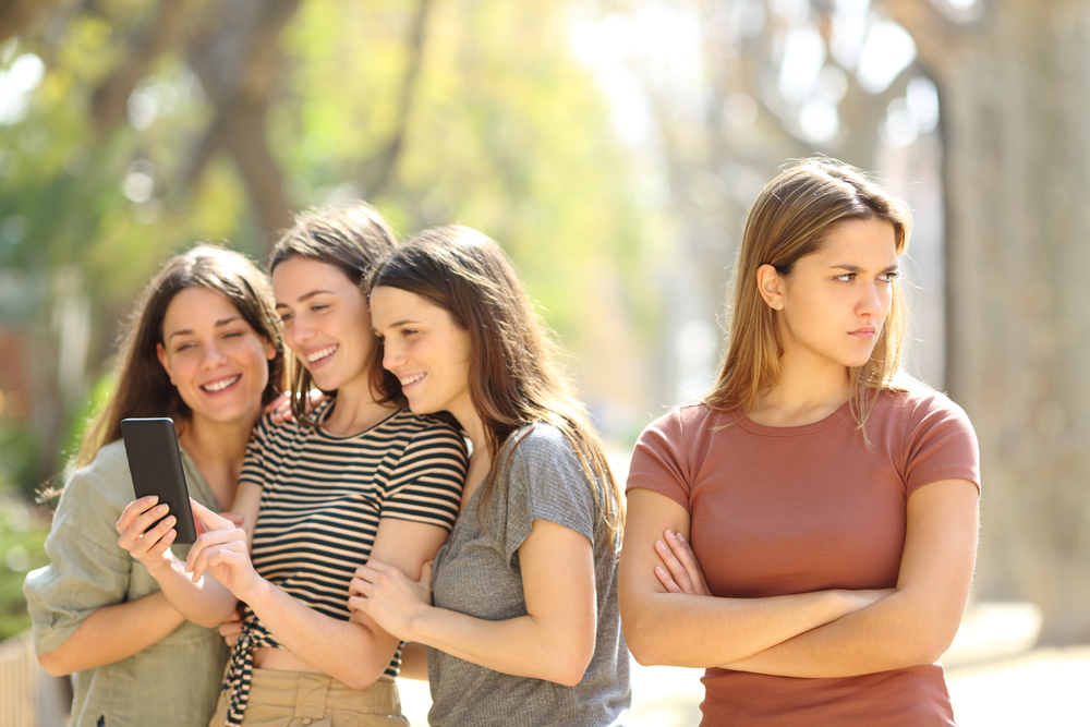 Angry,Woman,Being,Ignored,By,Her,Happy,Friends,Who,Are