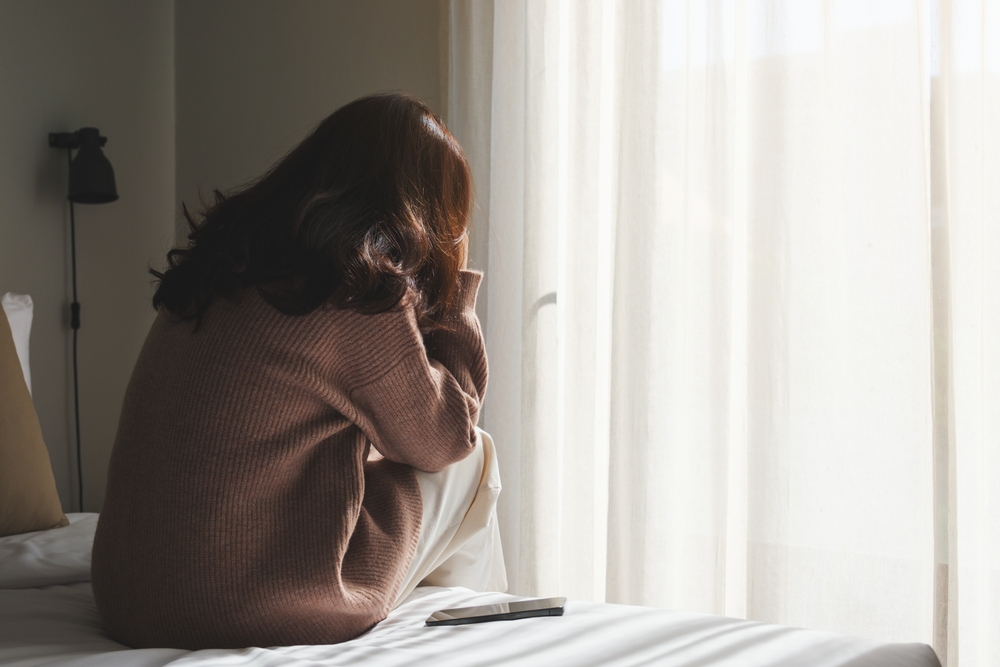 Rear,View,Of,A,Sad,Woman,After,Reading,Bad,News