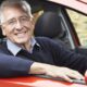 Old man smiling car driving