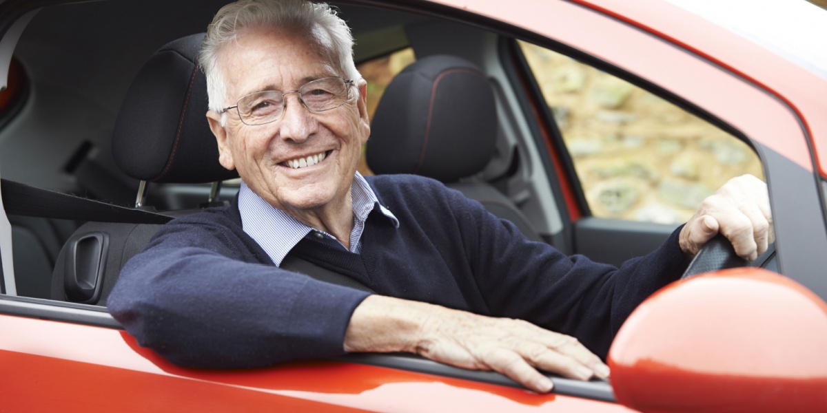 Old man smiling car driving